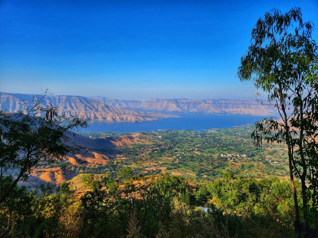 a scenic view of a lake surrounded by mountains